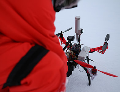 Zach Burchfield setting up a drone
